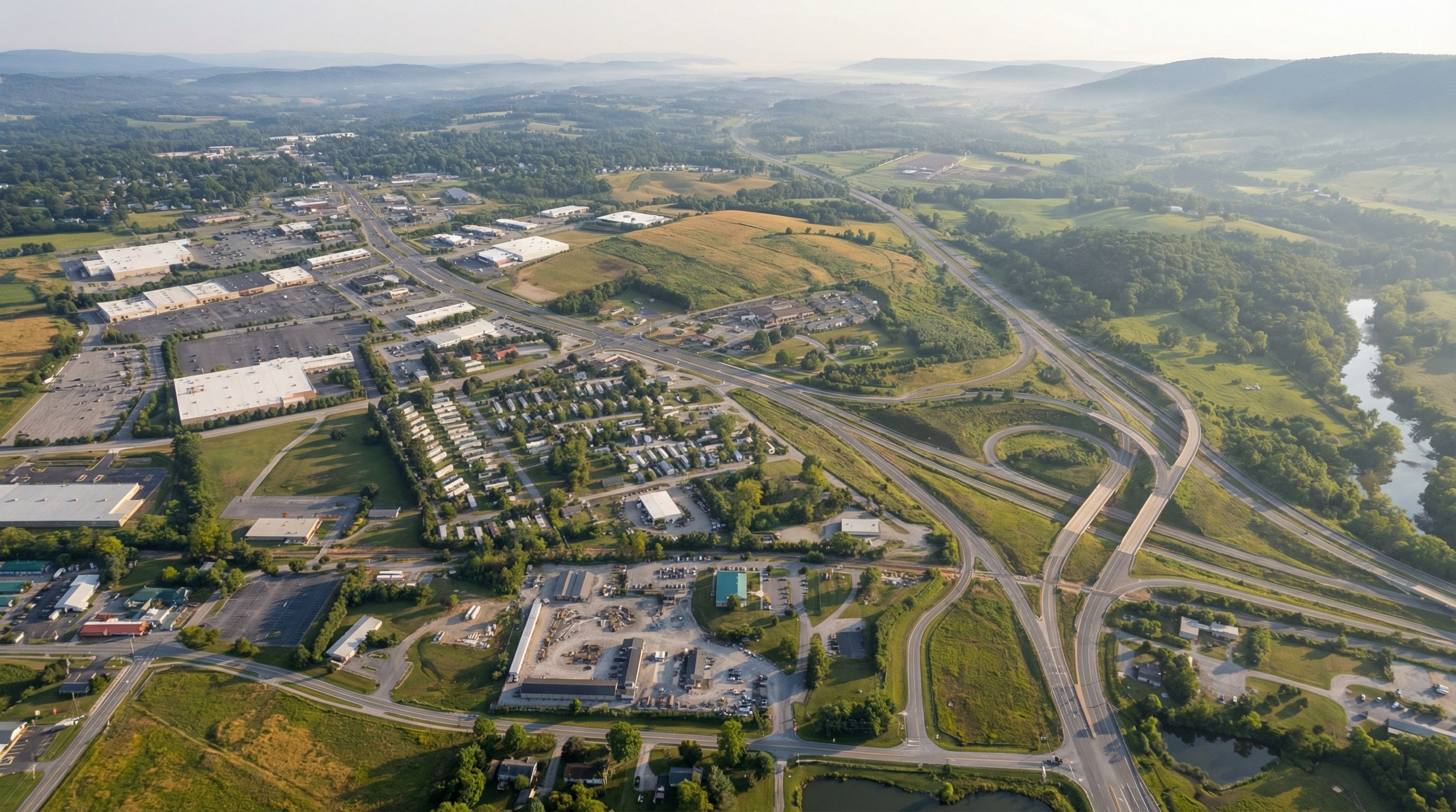 Wide view of Christiansburg neighborhoods, commercial corridors, and blue ridges beyond
