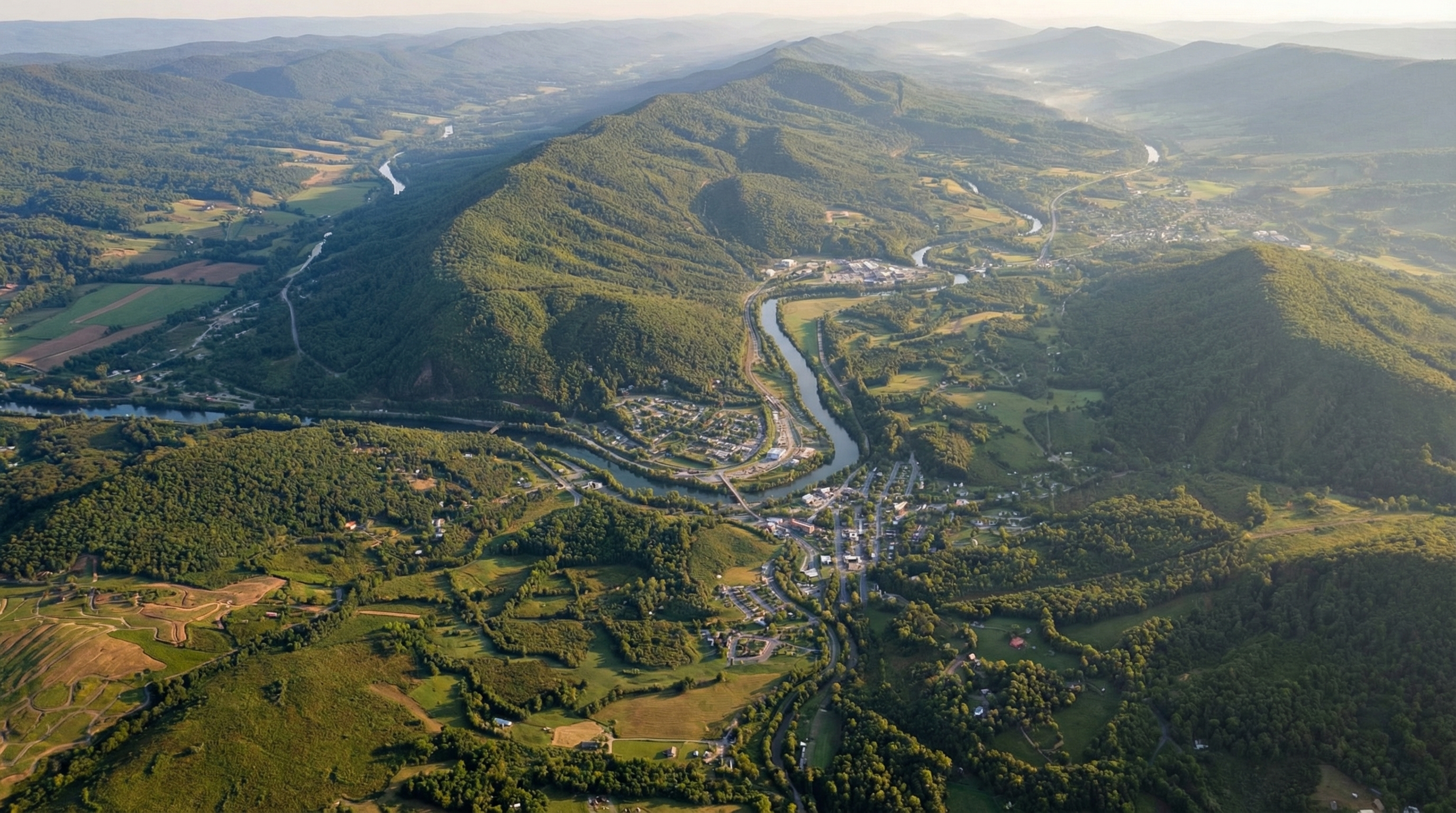Wide aerial view of Giles County valley communities, wooded slopes, and layered mountain ridges