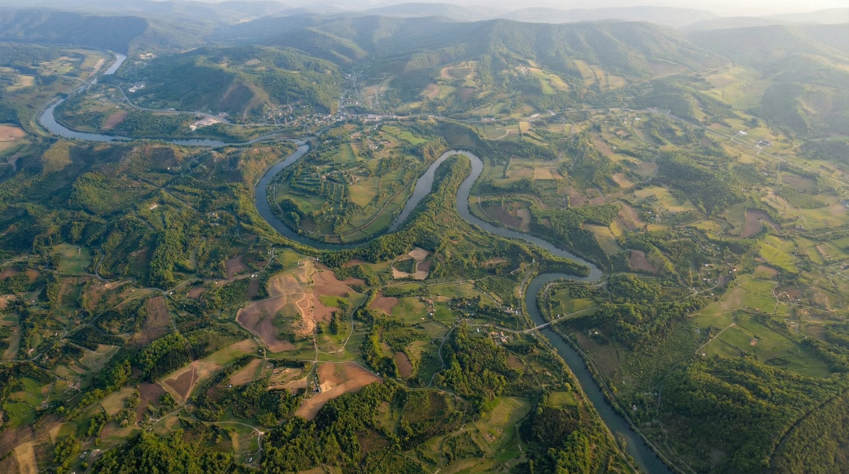 Wide aerial view of Montgomery County neighborhoods, farmland, and blue ridges
