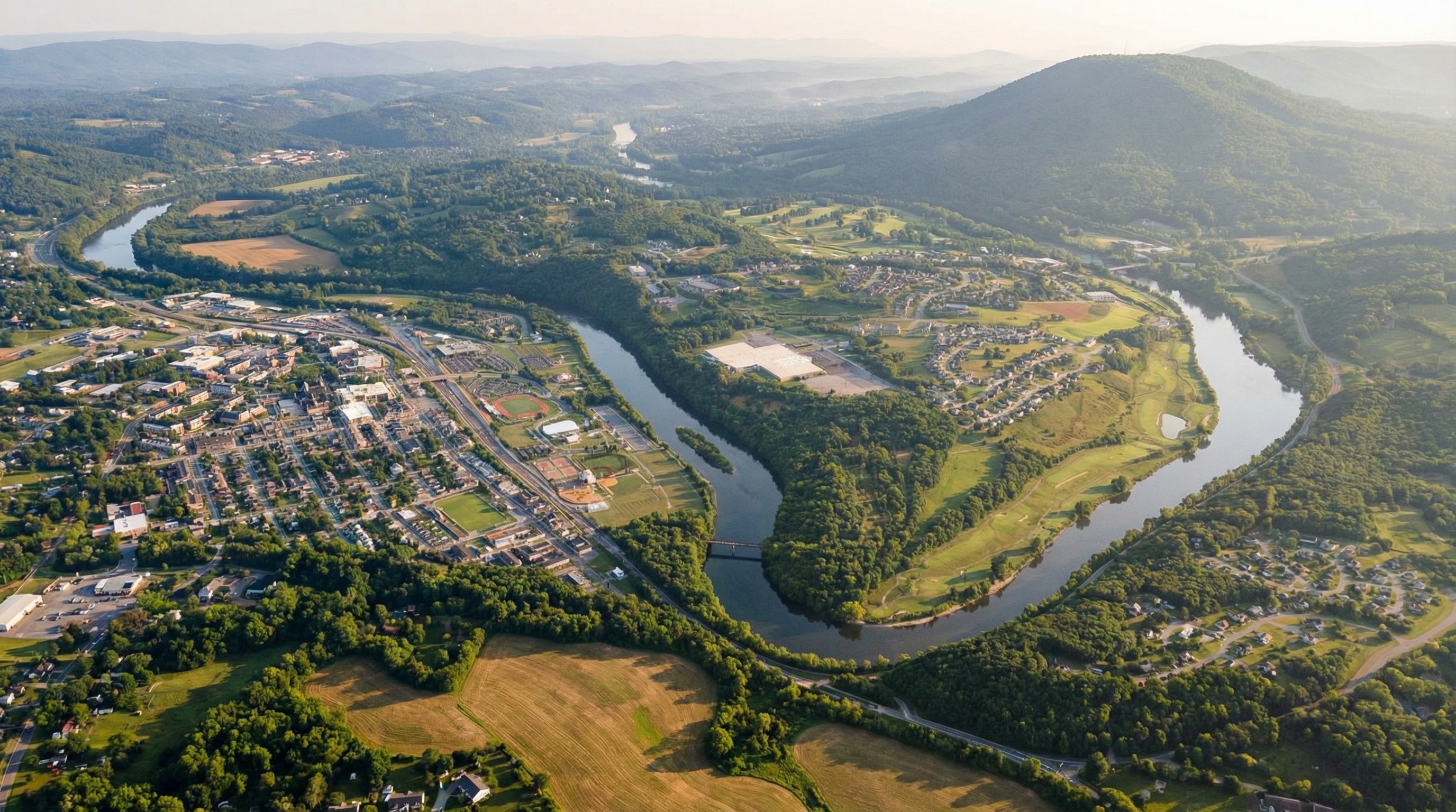 Wide view of Radford neighborhoods, tree-lined streets, and surrounding ridges