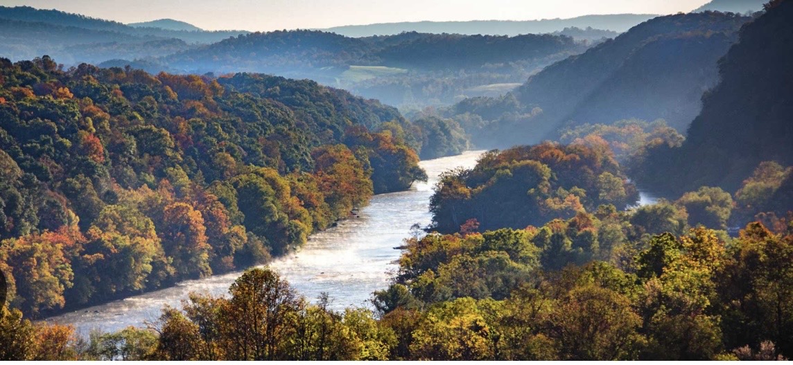 Wide aerial view of Giles County valley communities, wooded slopes, and layered mountain ridges