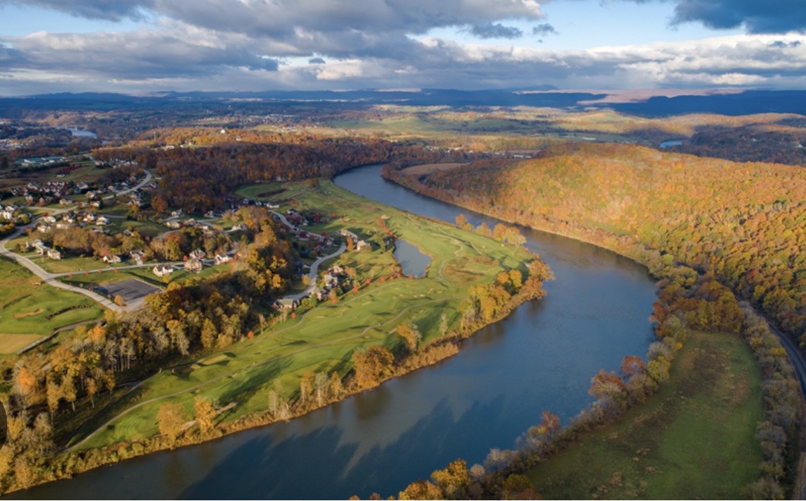 Wide aerial view of Pulaski County neighborhoods, open countryside, and water-backed ridges